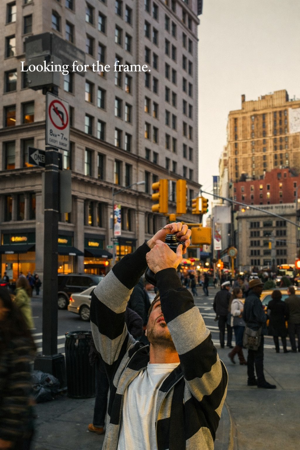 A photographer looking up to frame a shot of a high-rise building at a busy New York City intersection